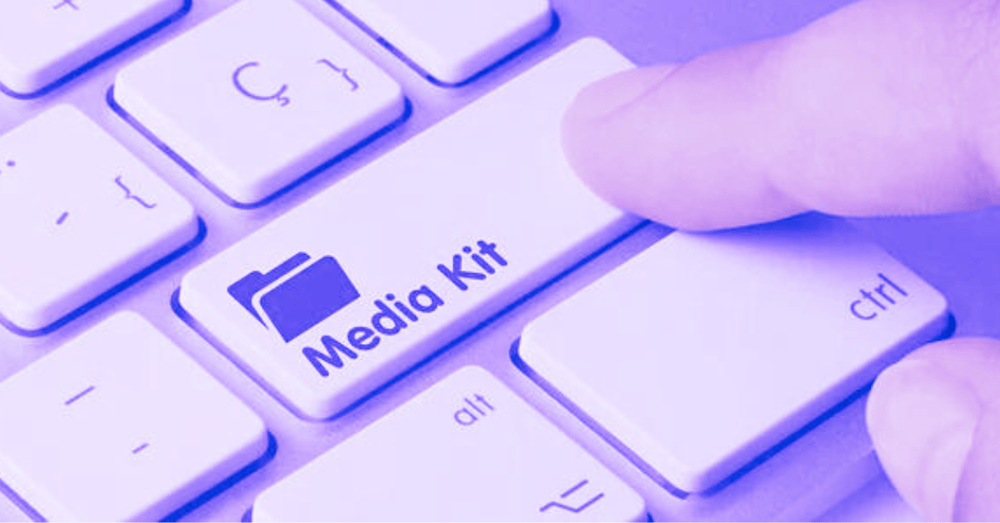 A close up of a keyboard key which says 'Media Kit' with a finger pressing it.