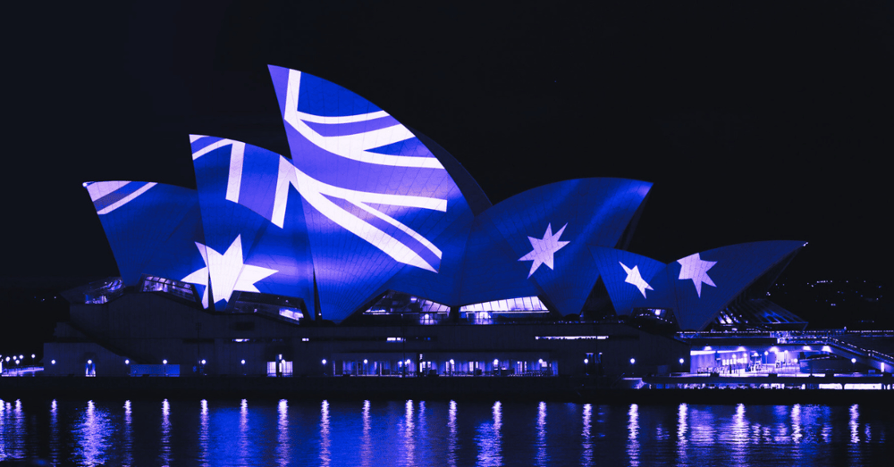 The Australian flag projected onto the Sydney Opera House at night